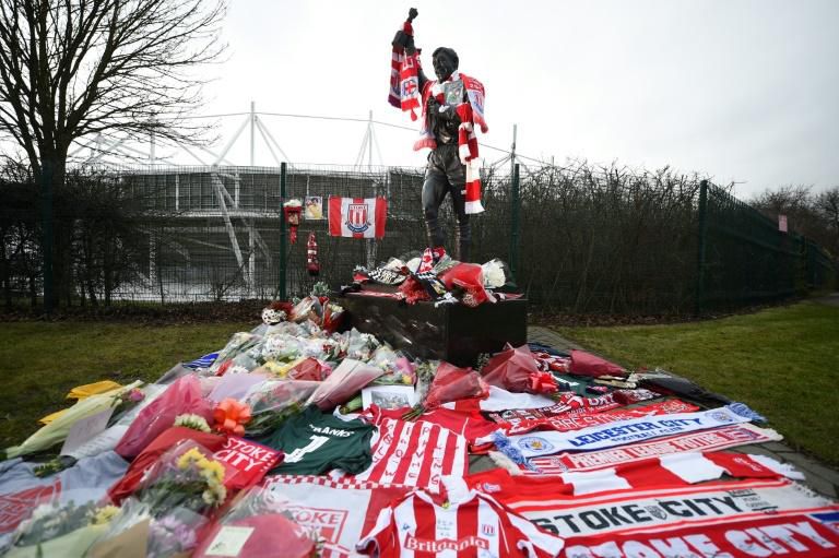 A statue of Stoke City and England's former goalkeeper Gordon Banks is draped in scarves and surrounded by floral tributes to honour England's World Cup winning goalkeeper, outside the Bet365 stadium in Stoke-on-Trent, central England