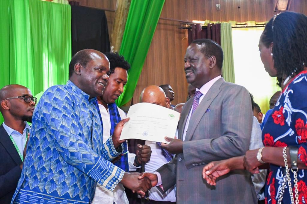 IEBC Chairperson Wafula Chebukati hands Azimio coalition's presidential candidate Raila Odinga official clearance to vie in the 2022 election on June 5, 2022 at the Bomas of Kenya National Tallying Centre