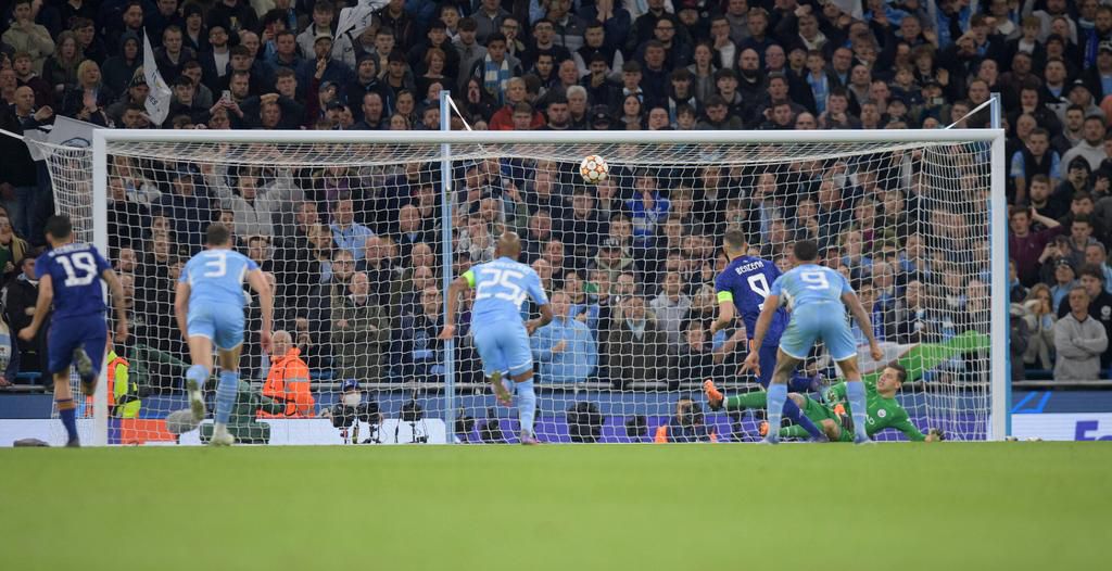 Ederson watches as Karim Benzema's audacious chip enters the goal