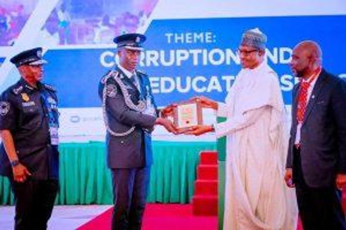 CSP Daniel Amah (left) receiving an award from President Muhammadu Buhari