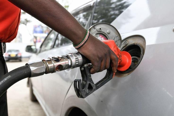 A pump attendant fills the tank of a car at a petrol station in September 4, 2018 in Nairobi as a 16 per cent VAT on petroleum products was decided and fuel distributors refused to collect stocks from depots. (Photo by SIMON MAINA/AFP via Getty Images)