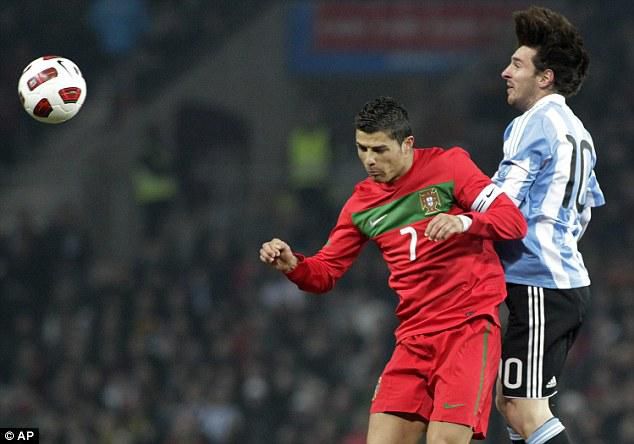 Soccer stars Cristiano Ronaldo (L) and Lionel Messi attempt a heading a ball during an international friendly in 2011
