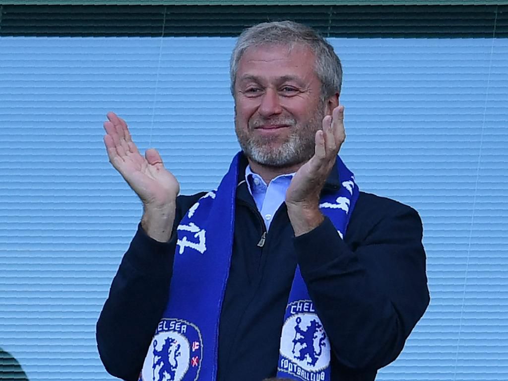 Abramovich wearing a Chelsea Football Club scarf.