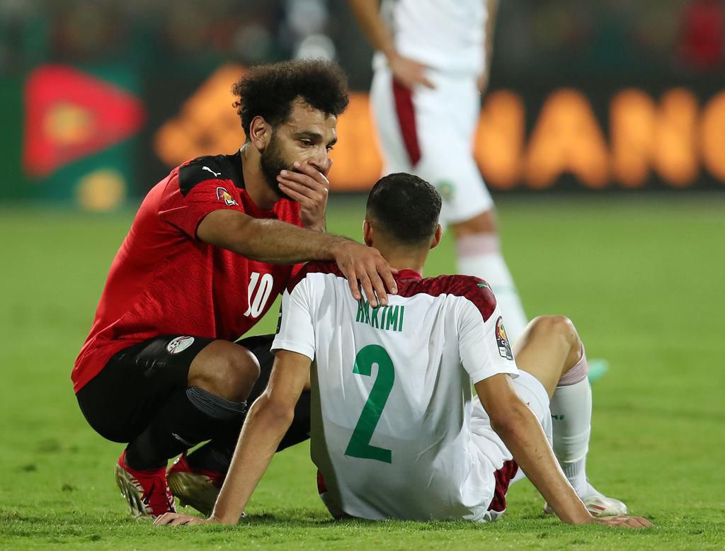 Egypt's Mohamed Salah (L) consoles Morocco's Achraf Hakimi (R) after their quater-final game