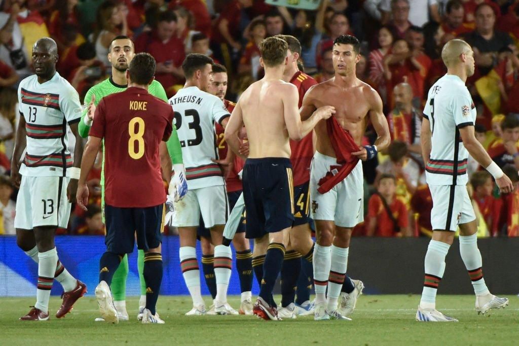 Portugal's forward Cristiano Ronaldo (2R) and Spain's defender Diego Llorente exchange their jerseys during the UEFA Nations League