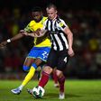 Nottingham Forest's Emmanuel Dennis (left) and Grimsby Town's Kieran Green battle for the ball during the Carabao Cup second round match