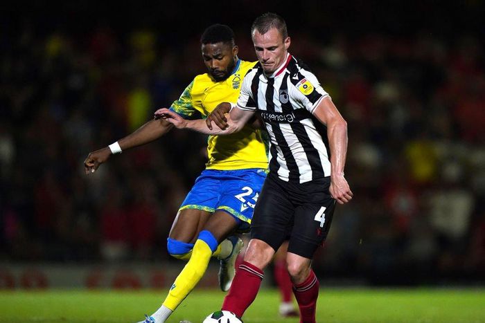 Nottingham Forest's Emmanuel Dennis (left) and Grimsby Town's Kieran Green battle for the ball during the Carabao Cup second round match