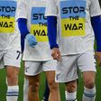Lazio team players wear a 'Stop the war' T-shirts referring to Russia's invasion of the Ukraine as they arrive to warm-up prior to the Italian Serie A football match between Lazio and Napoli at the Olympic stadium, in Rome