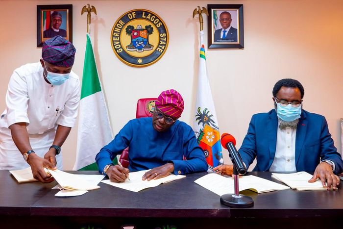 Lagos State Governor, Mr Babajide Sanwo-Olu, signing bills upgrading the Lagos State Polytechnic (LASPOTECH), Adeniran Ogunsanya College of Education (AOCOED) and Michael Otedola College of Primary Education (MOCPED) to universities, flanked by his Spe...
