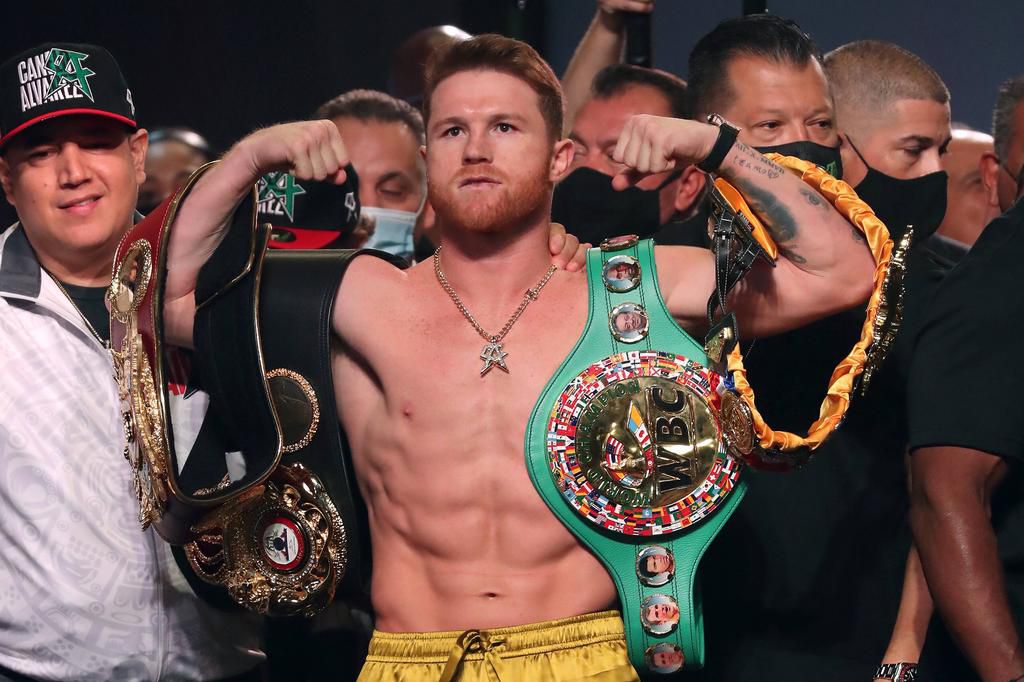 Boxer Canelo Alvarez posing with his titles