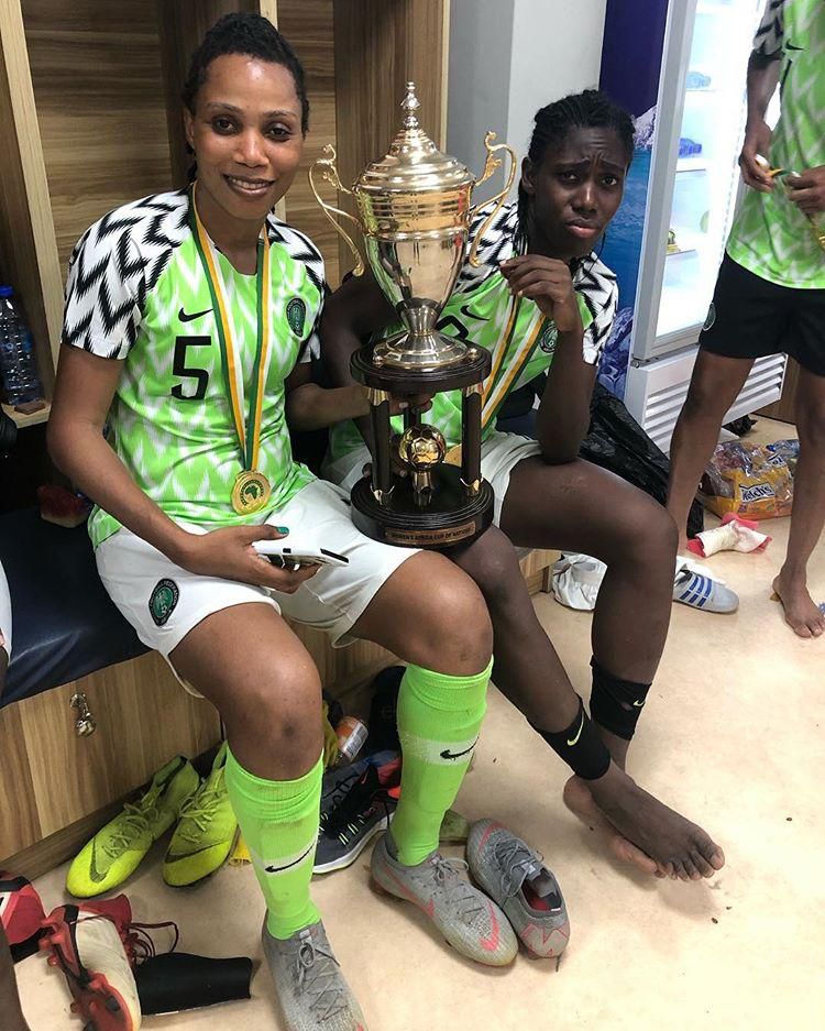 Onome Ebi and Asisat Oshoala pose with the AWCON trophy