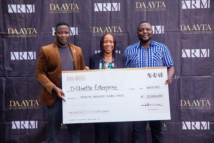 DAAYTA 2022 Winner Tunde Adeyemi, CEO of D-Olivette Enterprise, (left), receiving the prize from Ms. Jumoke Ogundare CEO of ARM, (middle), with Idris Salami, Co-Founder, D-Olivette Enterprise, (Right), at the Prize Award ceremony.