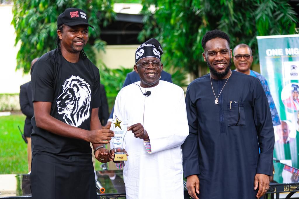 Former Super Eagles' captain Nwankwo Kanu (L) and Austin JJ Okocha presenting All Progressives Congress National Leader, Asiwaju Bola Tinubu, an award when the ex-internationals visited Tinubu in Ikoyi, Lagos on Saturday.