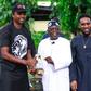 Former Super Eagles' captain Nwankwo Kanu (L) and Austin JJ Okocha presenting All Progressives Congress National Leader, Asiwaju Bola Tinubu, an award when the ex-internationals visited Tinubu in Ikoyi, Lagos on Saturday.