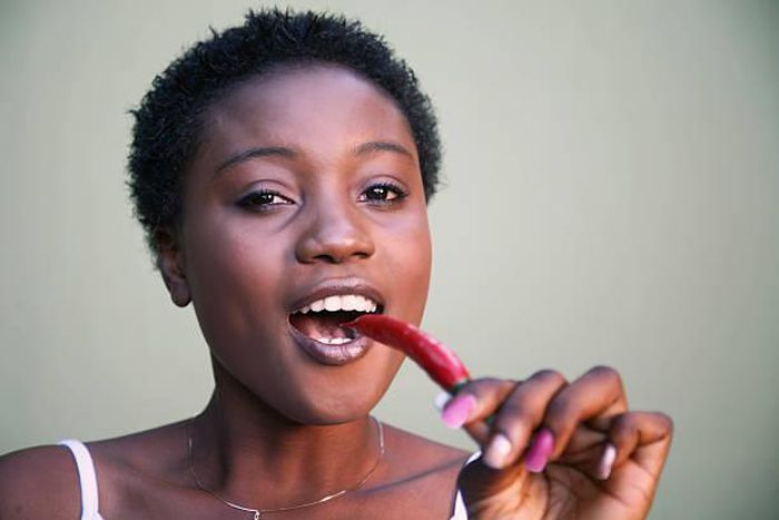 Woman eating hot peppers