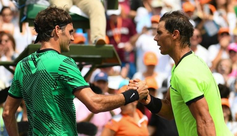 Roger Federer of Switzerland (L) and Rafael Nadal of Spain shake hands after Federer defeated Nadal in the men's final match on day 14 of the Miami Open at Crandon Park Tennis Center on April 2, 2017 in Key Biscayne, Florida