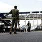 A Nigerian police officer in Lagos flags down an oncoming vehicle at a checkpoint to enforce an extended lockdown as part of measures to prevent the spread of COVID-19