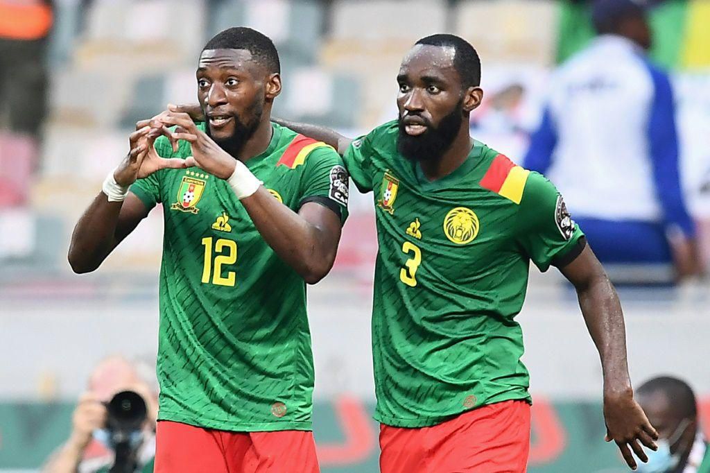 Karl Toko Ekambi (L) celebrates with Moumi Ngamaleu after scoring the first of his two goals in Cameroon's win over Gambia in Douala