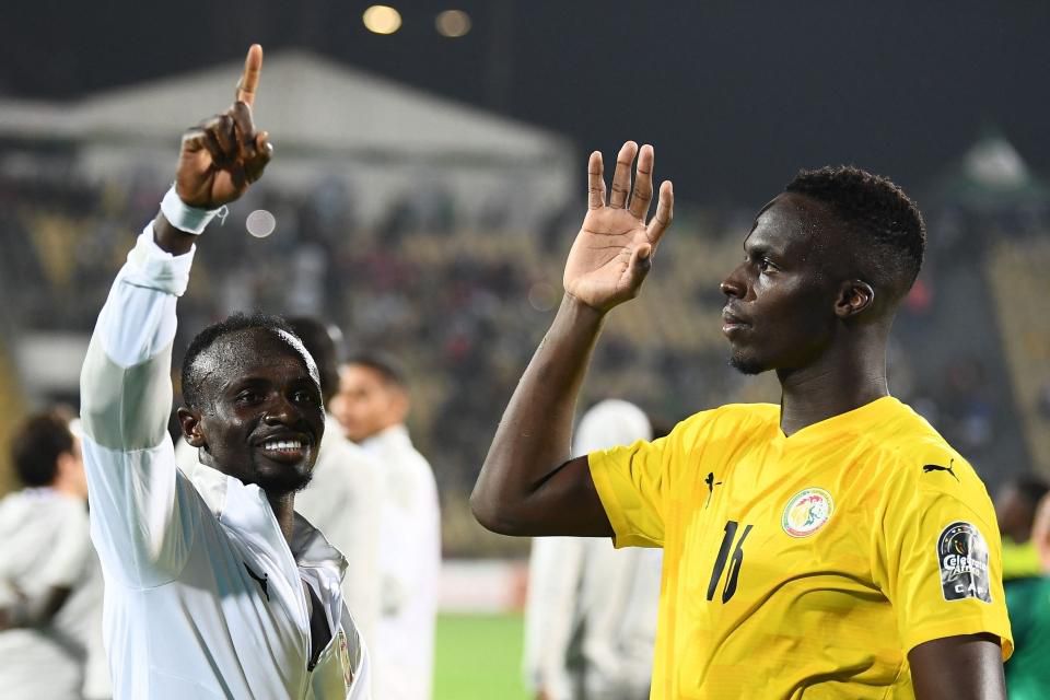 Sadio Mane celebrates Senegal's victory with Chelsea's Edouard Mendy