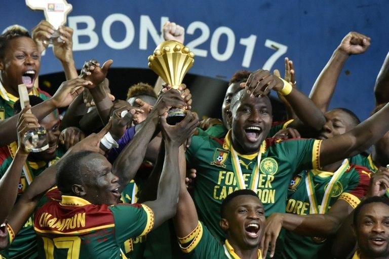 Cameroon's players celebrate with the winner's trophy after defeating Egypt 2-1 to win the 2017 Africa Cup of Nations, at the Stade de l'Amitie Sino-Gabonaise in Libreville, on February 5