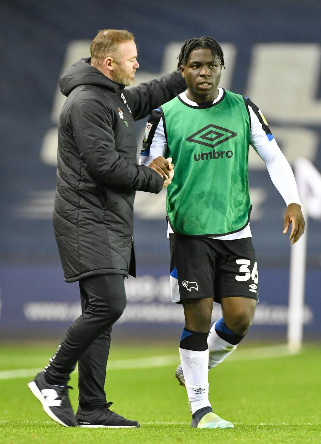 Ebosele and Rooney on the touchline