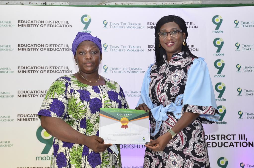L-R- Fuja Temitope receiving the certificate of participationfrom PR Lead, 9mobile, Chineze Amanfo, during 9mobile Train-The-Trainerworkshop for teachers in Education District III Lagos.