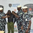 Police officer, Richard Gele, being stripped of Police uniform. [Daily Trust]