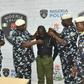 Police officer, Richard Gele, being stripped of Police uniform. [Daily Trust]