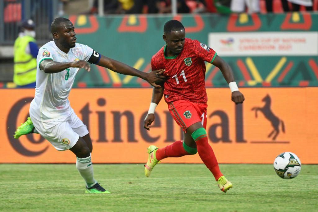 Senegal captain Kalidou Koulibaly (L) chases Malawi forward Gabadinho Mhango  during an Africa Cup of Nations Group B match in Bafoussam on Tuesday