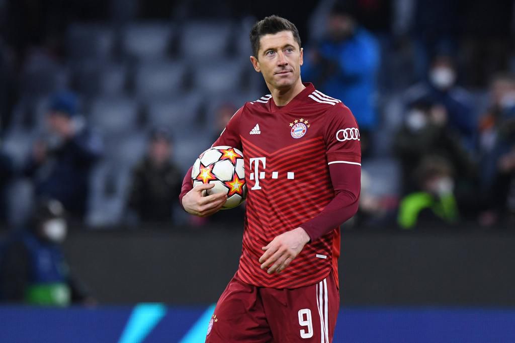 Lewandowski holds his match ball after scoring a first-half hat trick against Salzburg on Tuesday night