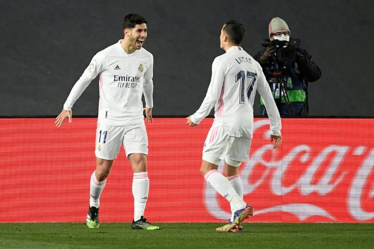 Double act: Marco Asensio celebrates after Lucas Vazquez set up his goal against Celta