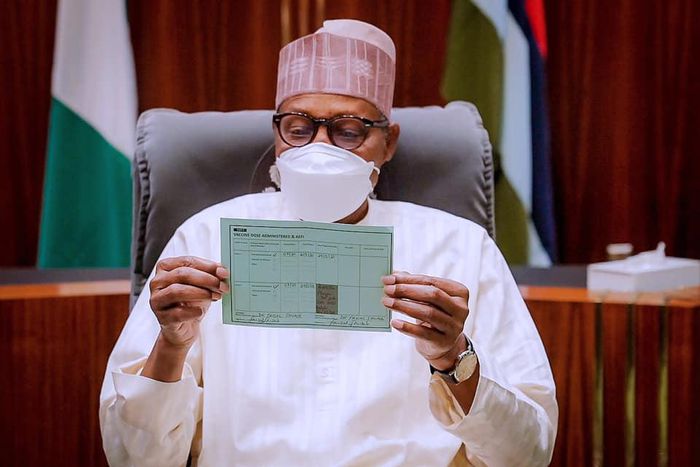 President Muhammadu Buhari displays his COVID-19 vaccine card [Presidency]