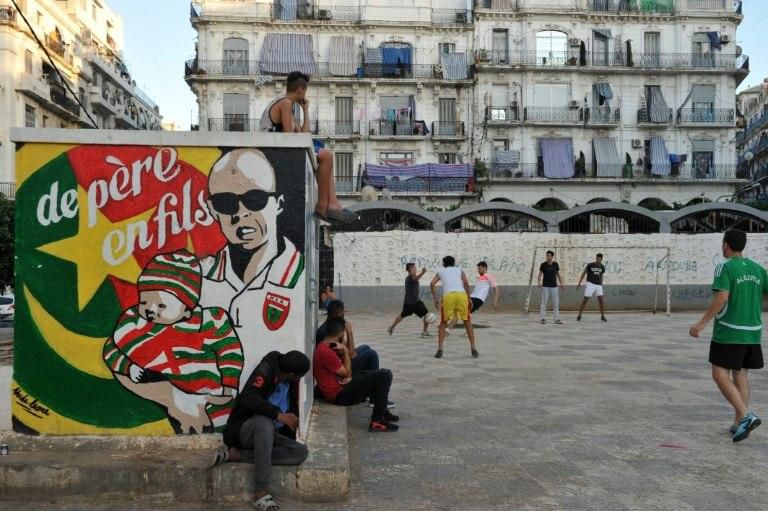 Algerians play football in Algiers' Bab el-Oued neighbourhood, which is historically known to be a predominantly pro-Mouloudia Club Alger (MCA) area