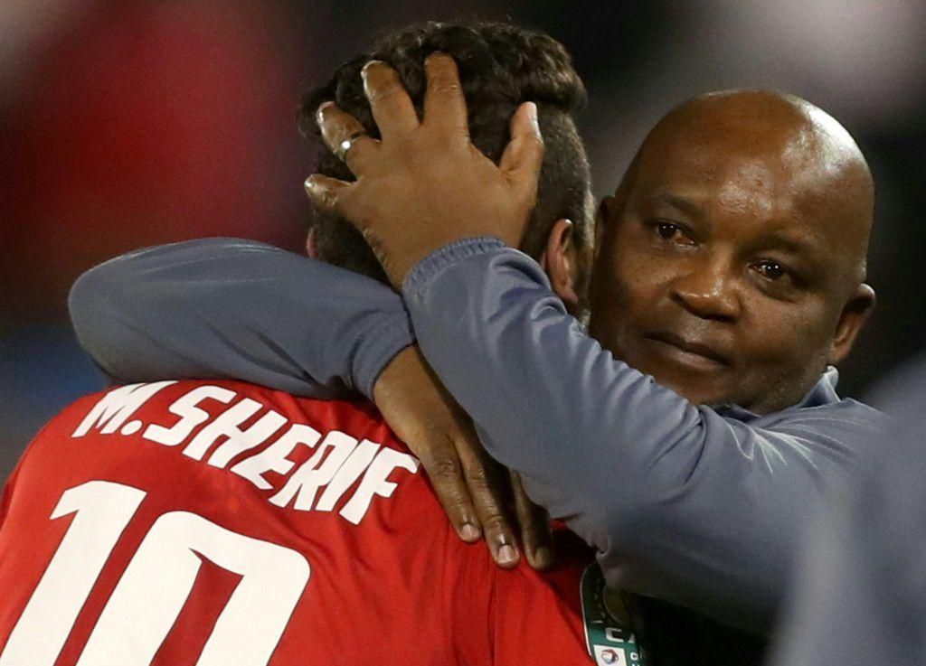 Al Ahly coach Pitso Mosimane (R) celebrates with star forward Mohamed Sherif (L) after the Egyptian club won the CAF Super Cup last May.