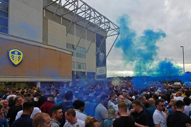 Leeds United supporters gather outside their Elland Road ground to celebrate promotion