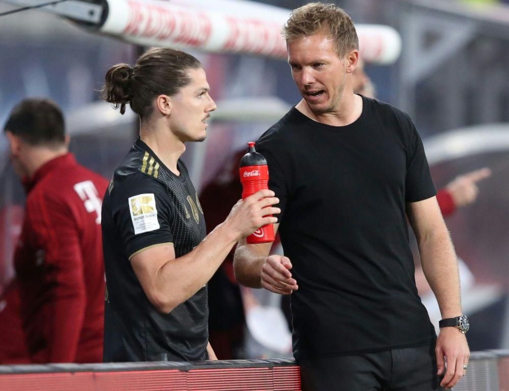 Bayern Munich head coah Julian Nagelsmann (R) speaks to Marcel Sabitzer, who made his club debut at Leipzig on Saturday