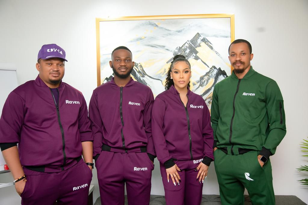 The reality TV star flanked by top management of the Raven Bank