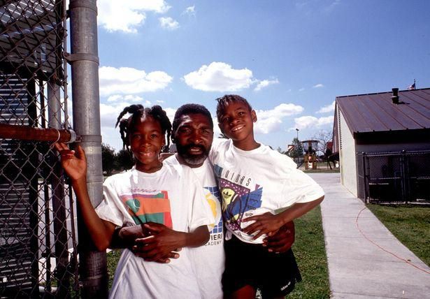 The young Venus and Serena Williams pose with their father Richard in 1991 in Compton
