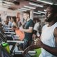 Sweaty black athlete running on treadmill in a gym.