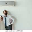 A man standing under an air condition