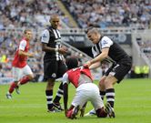 Joey Barton aggressively pulls Gervinho up after the Arsenal forward had gone down in search of a penalty