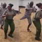 Female prison warden dances with inmate