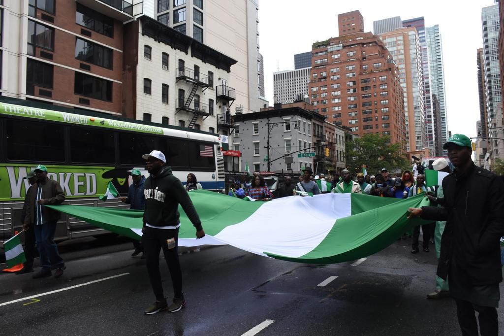 Some officials of the Consulate General of Nigeria in New York carrying Nigeria flag at a parade to commemorate the 62nd Independence Day in New York on Saturday in New York.