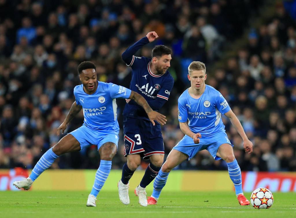 Raheem Sterling, Oleksandr Zinchenko and Lionel Messi vie for the ball
