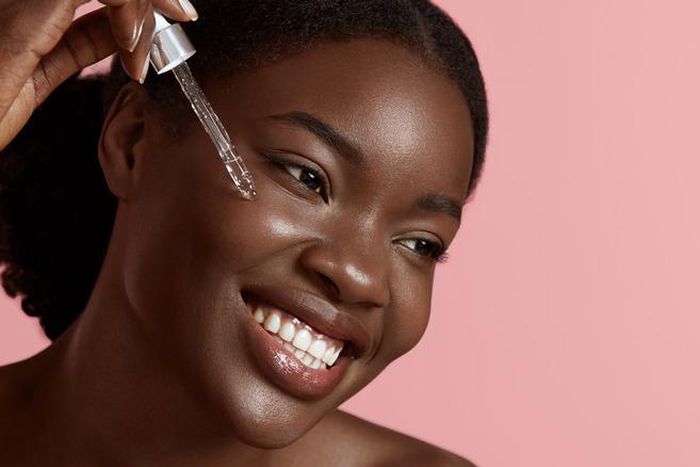 Lady using Vitamin C serum