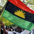 An IPOB supporter holding a Biafran flag