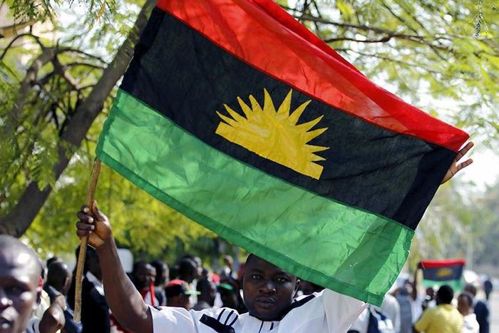 An IPOB supporter holding a Biafran flag