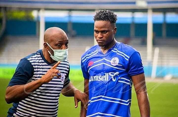 Rivers United's star Rafiu Kayode Isaq taking instructions from his coach.