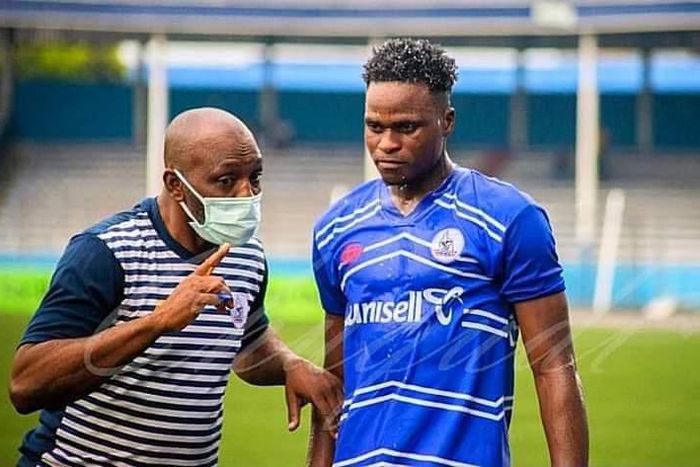 Rivers United's star Rafiu Kayode Isaq taking instructions from his coach.