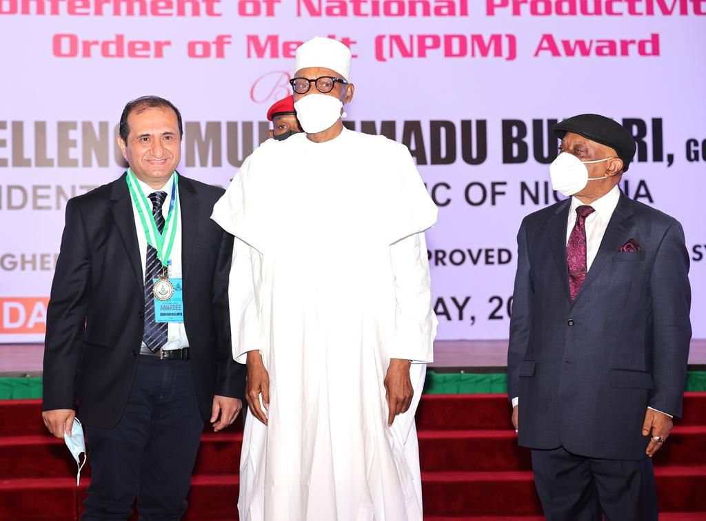 President Muhammadu Buhari flanked by Managing Director, Crown Flour Mill (CFM) Limited, Mr. Ashish Pande (left), and Minister of Labour and Employment, Dr. Chris Ngige, at the presentation of the National Productivity Order of Merit Award to CFM, hel...